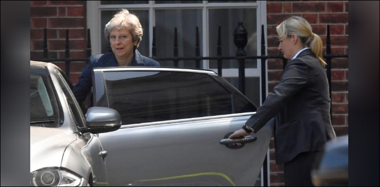 Under pressure to soften Brexit plans, May signals faster pace