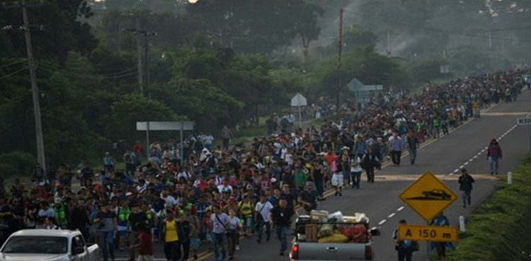 Trump says US to start cutting aid as migrant caravan rolls on