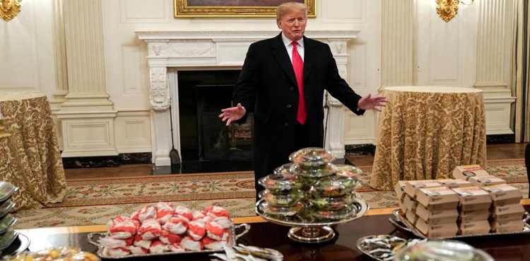 Burgers by candlelight: Trump lays out fast food for college football champs