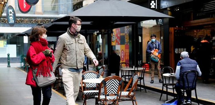 Australia cuts Covid isolation time, eases mask rules