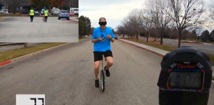 Blindfolded man completes 463 juggling catches while riding unicycle