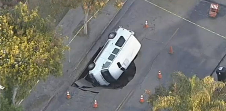 WATCH: Sinkhole swallows family's parked van