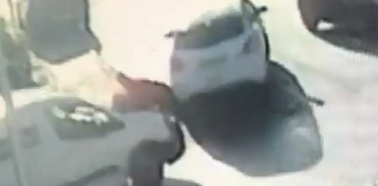 Delivery driver clings on to van's bonnet to stop it being stolen