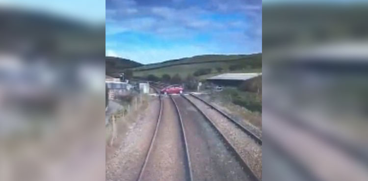 WATCH: Car driver comes within seconds of being hit by speeding train