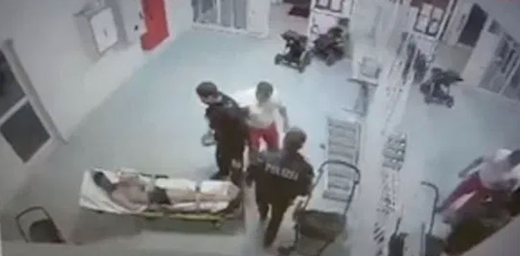 German paramedic punches strapped-down Syrian refugee