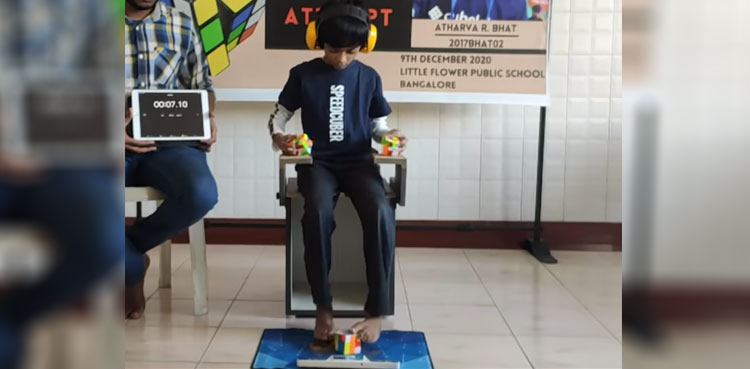 WATCH: Eight-year-old solves three Rubik's Cubes simultaneously; sets record