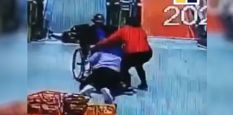 WATCH: Woman saves elderly man in wheelchair rolling down escalator