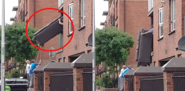 WATCH: Men trying to move sofa out of a window