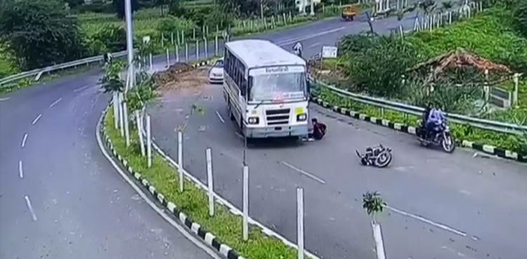 WATCH: Motorcyclist run over by a bus, escapes unhurt