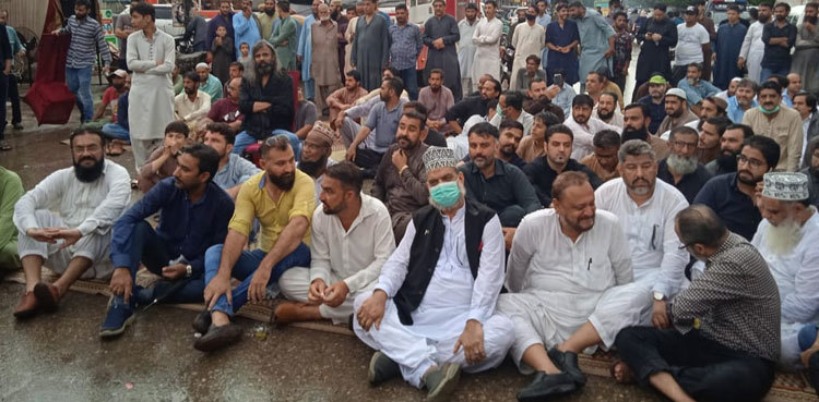 Unfazed by rain, Karachi traders stage sit-in against restrictions