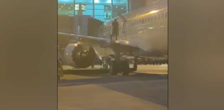 Watch: Man climbs on wing of a moving aircraft