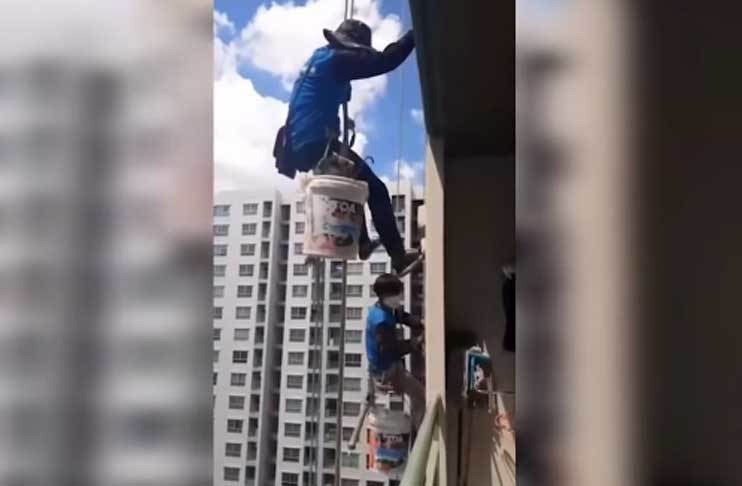 Watch: Painters working in building saved after woman cuts support rope