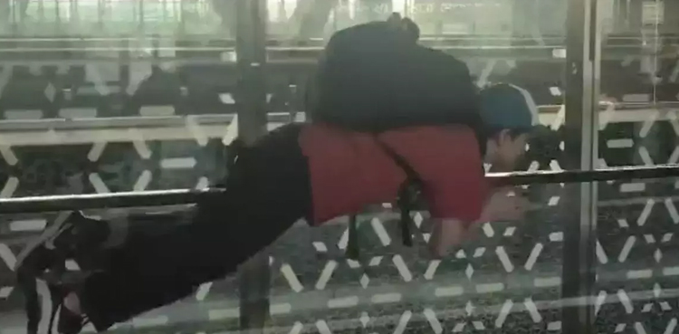Boy "flies" like Superman at airport, video goes viral