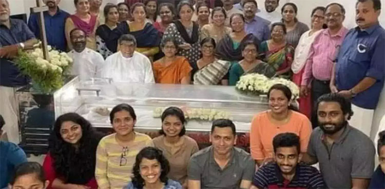 Family defends photo showing them smiling around mother's casket