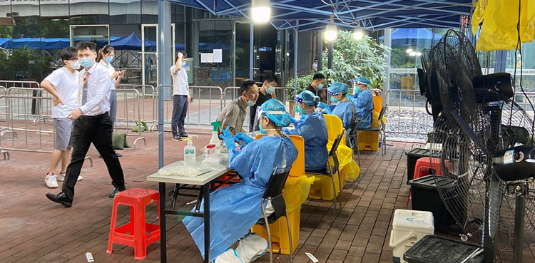 China says COVID outbreak easing on eve of travel rush