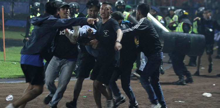 'Fans died in players' arms,' says coach at Indonesia football tragedy