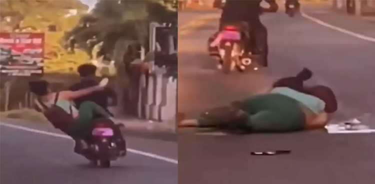 Viral video: Woman falls off the bike while kicking another rider