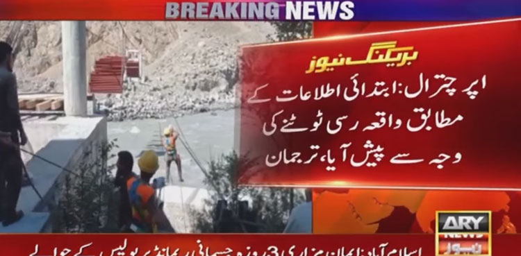 Chairlift with three people stuck midair over Chitral river