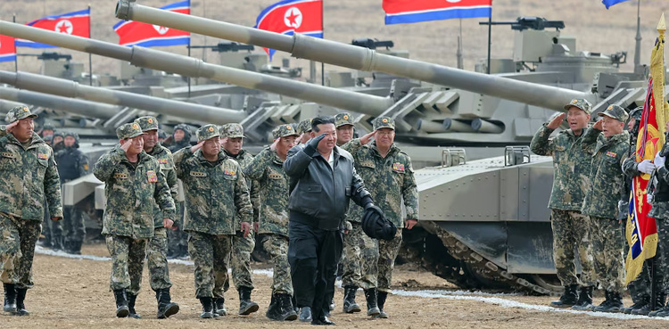 North Korea's Kim 'drives' new tank during mock battle