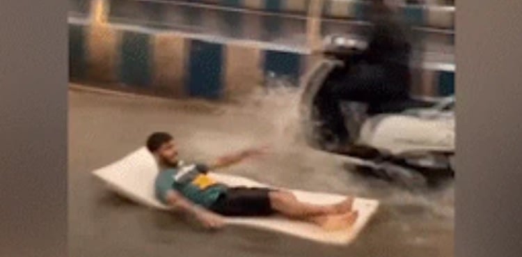 WATCH: Man floats on mattress on waterlogged road after heavy rain
