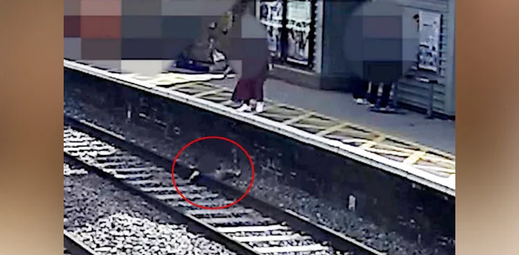 WATCH: Child falls onto track saved by stranger as train pulls into station