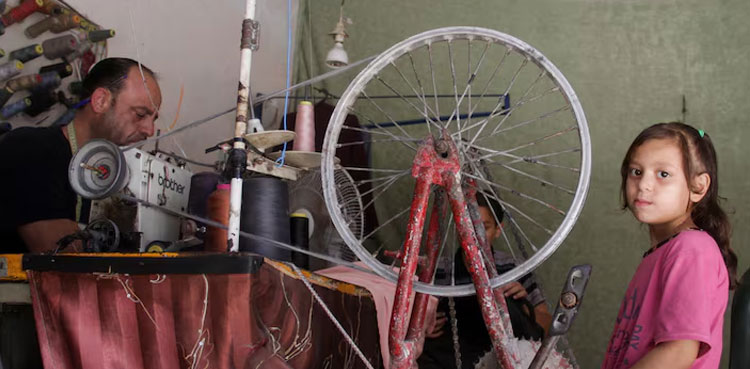 Gaza tailor turns to bicycle to power sewing machine