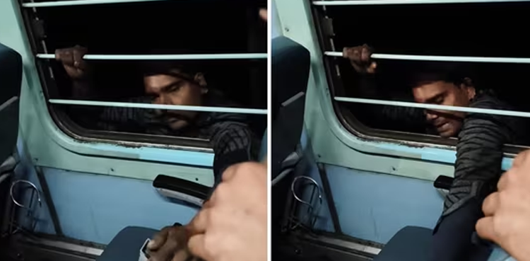 WATCH: Daring 'thief' hangs from moving train window in bold stunt