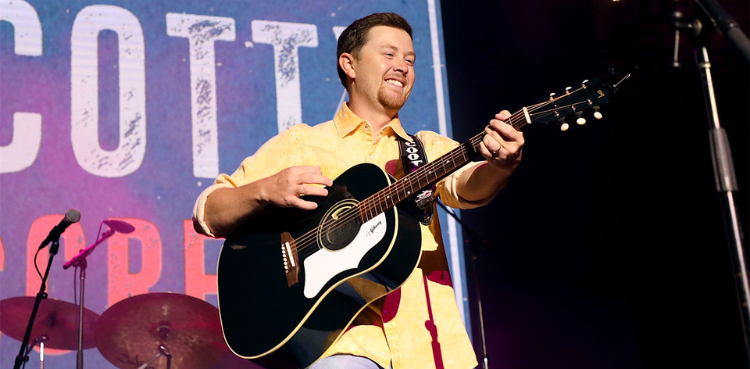 American Idol winner Scotty McCreery takes a tumble mid performance – Watch