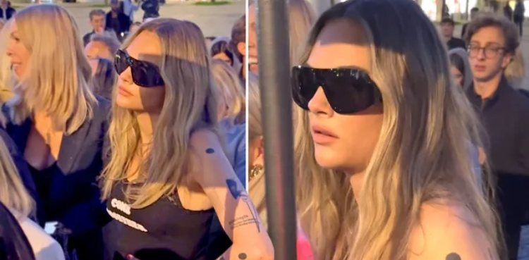 Cara Delevingne waits in line at Paris Fashion Week