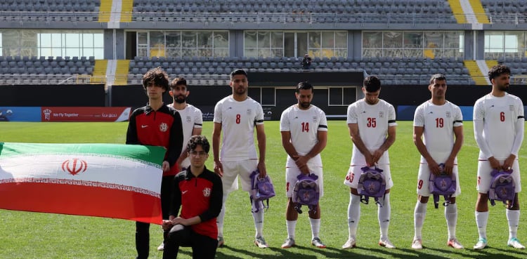Iranian soccer players hold schoolbags in solidarity with slain girls