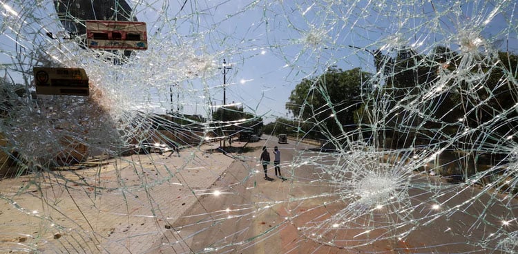 Police fire tear gas as workers' protest in India's Noida turns violent