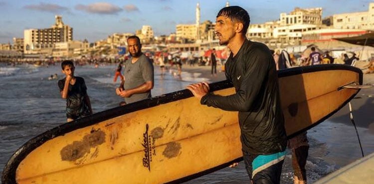 Gaza’s surfers seek solace in the sea