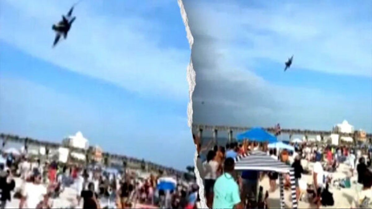 Terrifying moment low-flying fighter jet roars over beachgoers in viral footage